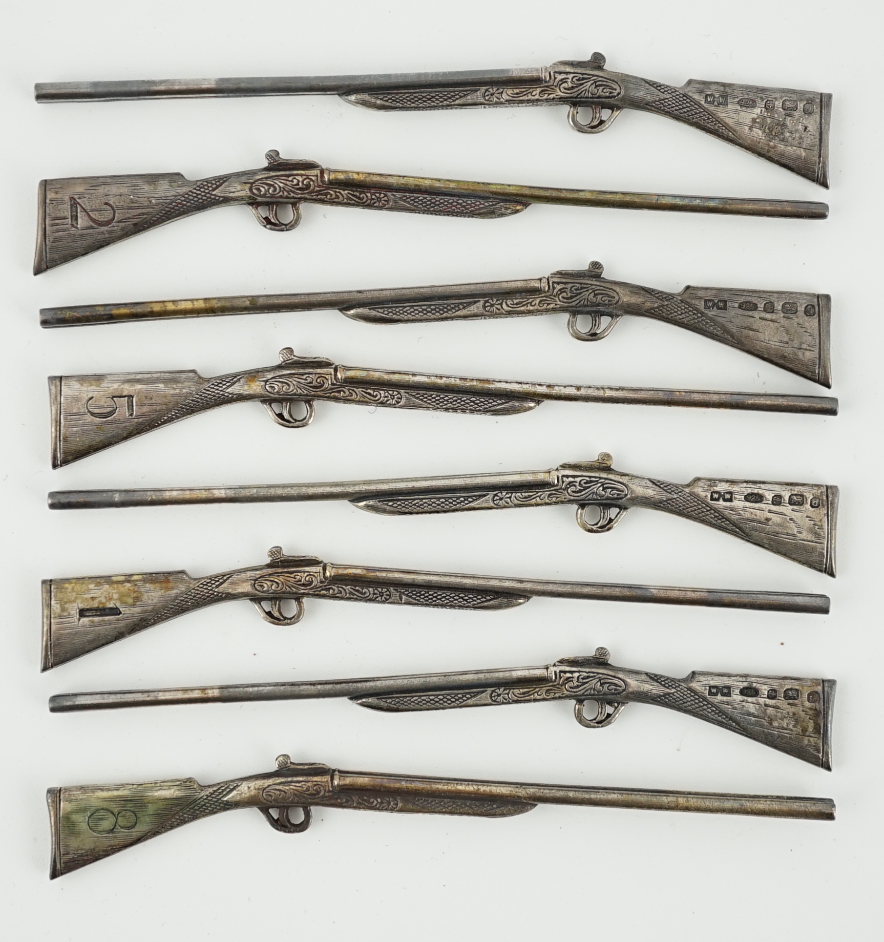 A modern set of eight novelty silver butt markers, modelled as double barrelled shotguns